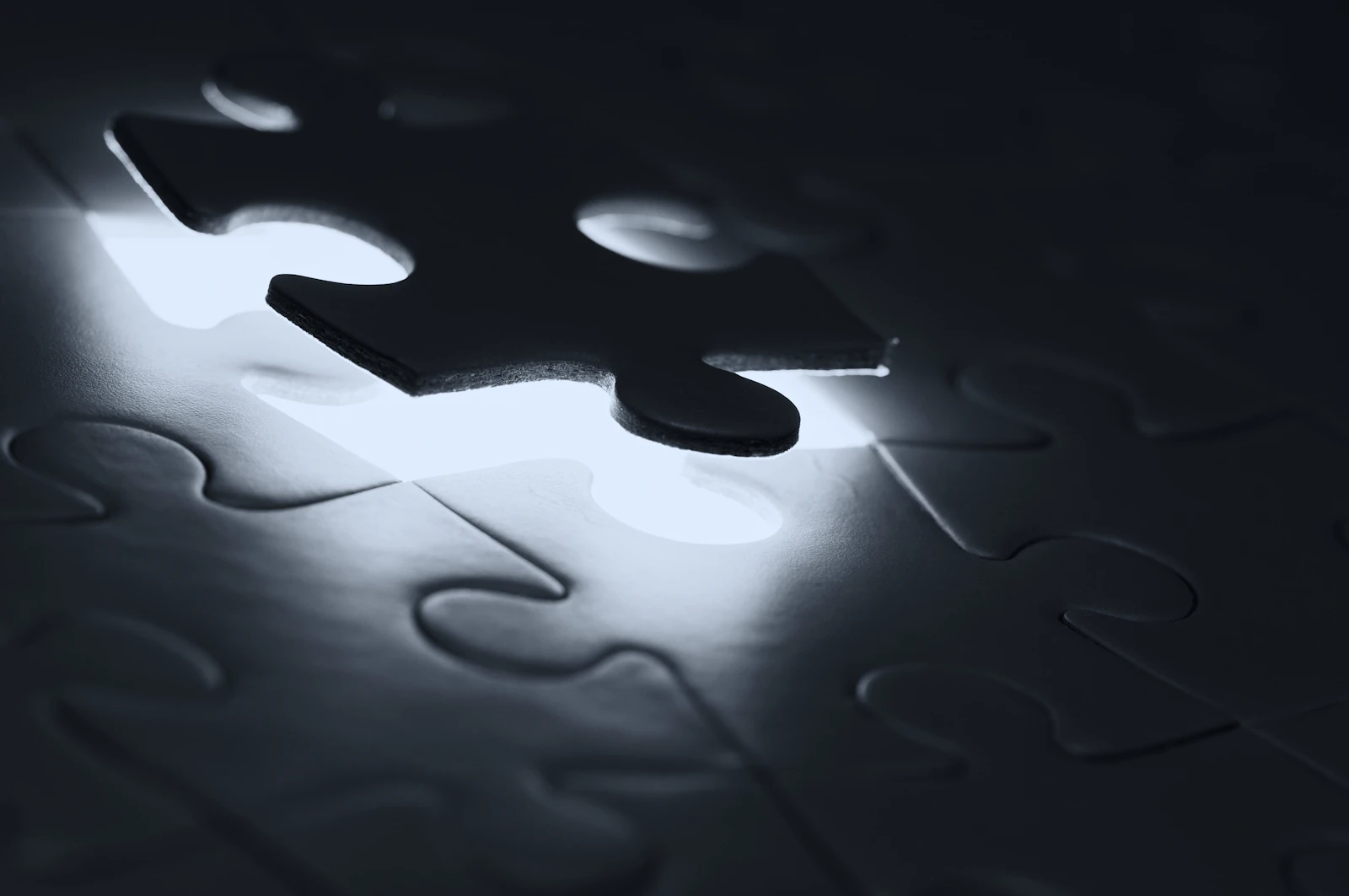 A single dark puzzle piece hovering above its matching empty slot